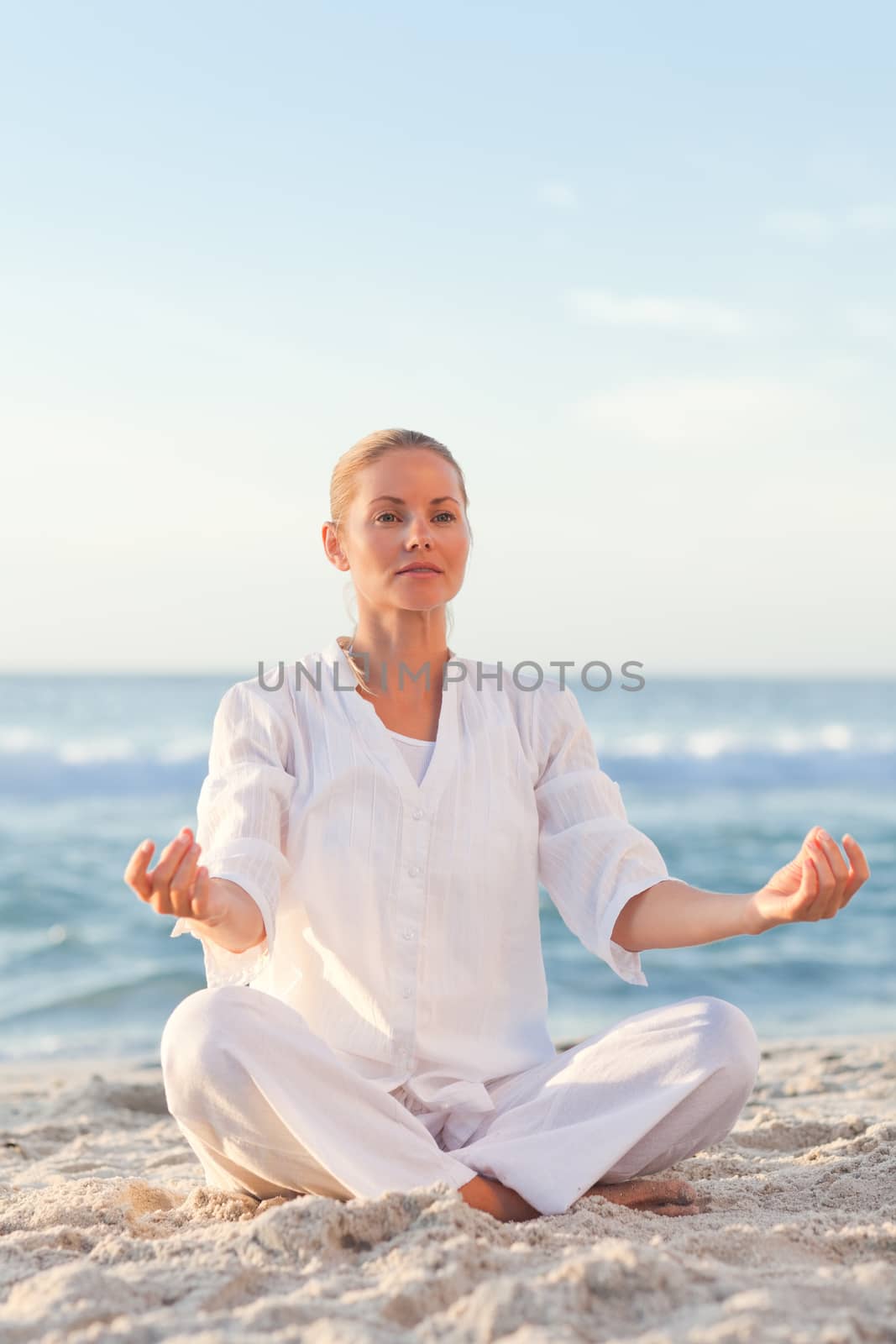 Peaceful woman practicing yoga  by Wavebreakmedia