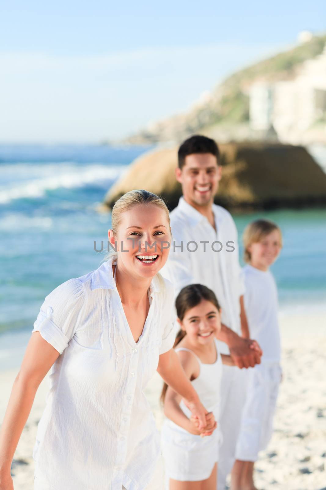 Portrait of a cute family at the beach by Wavebreakmedia