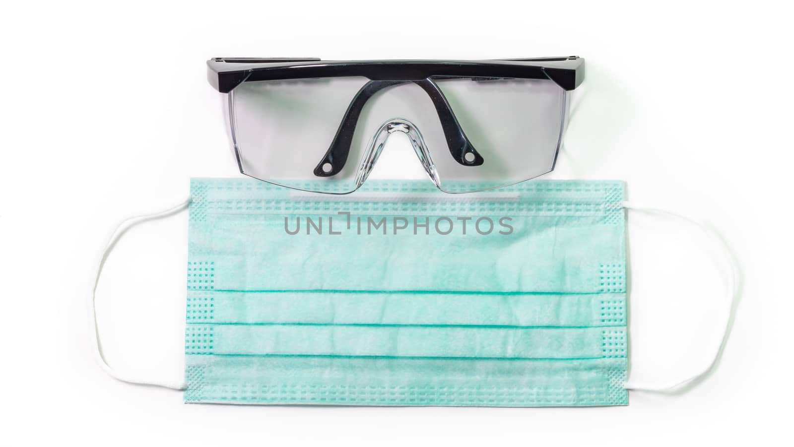 The close up of Anti-viral protection mask and Eye protection glasses on white background.