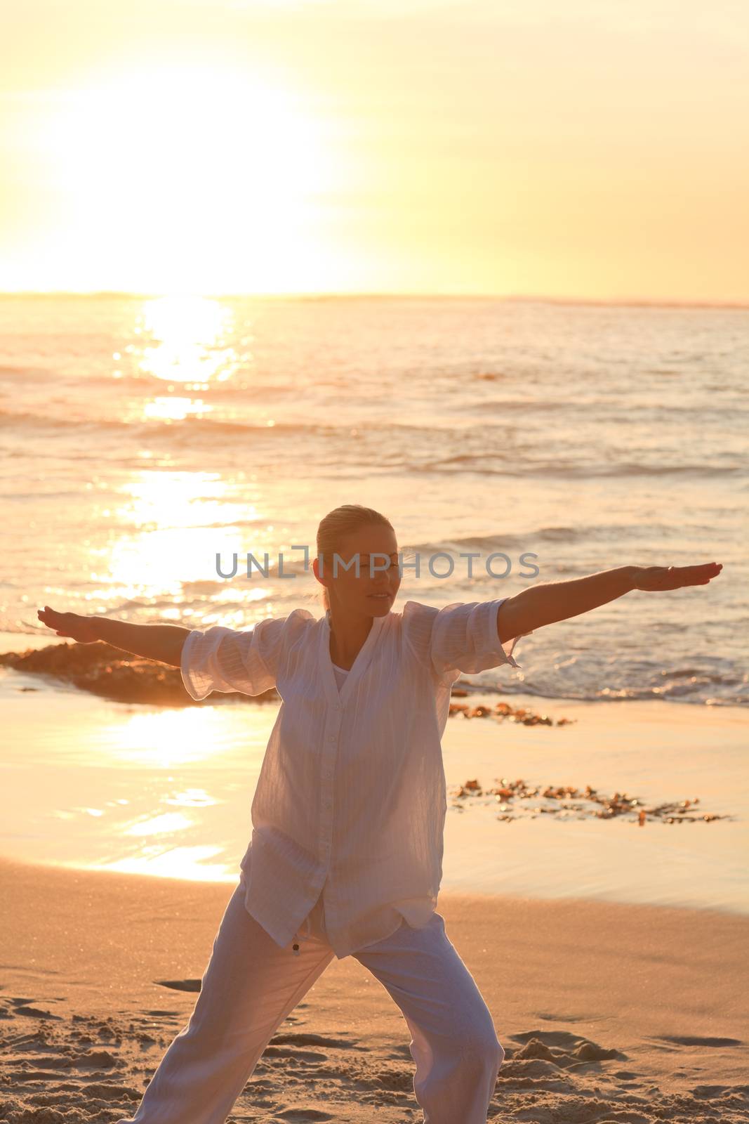 Woman practicing yoga against the sea by Wavebreakmedia