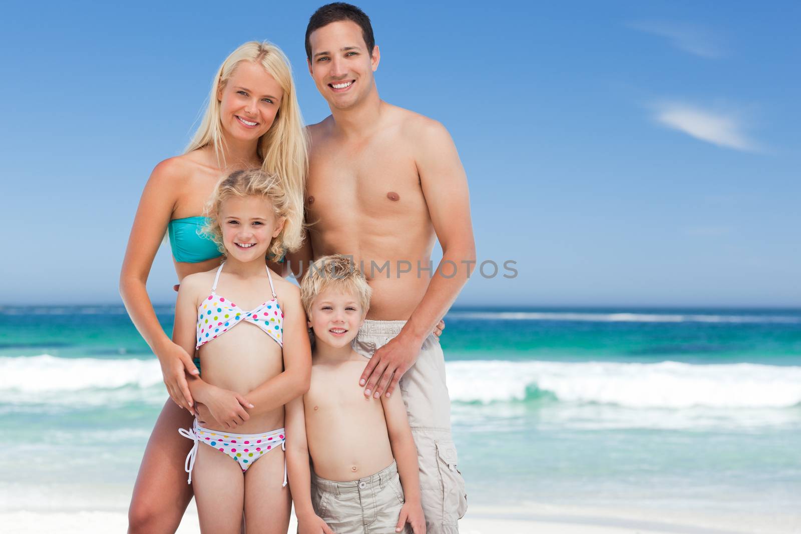 Happy family on the beach against the sea by Wavebreakmedia