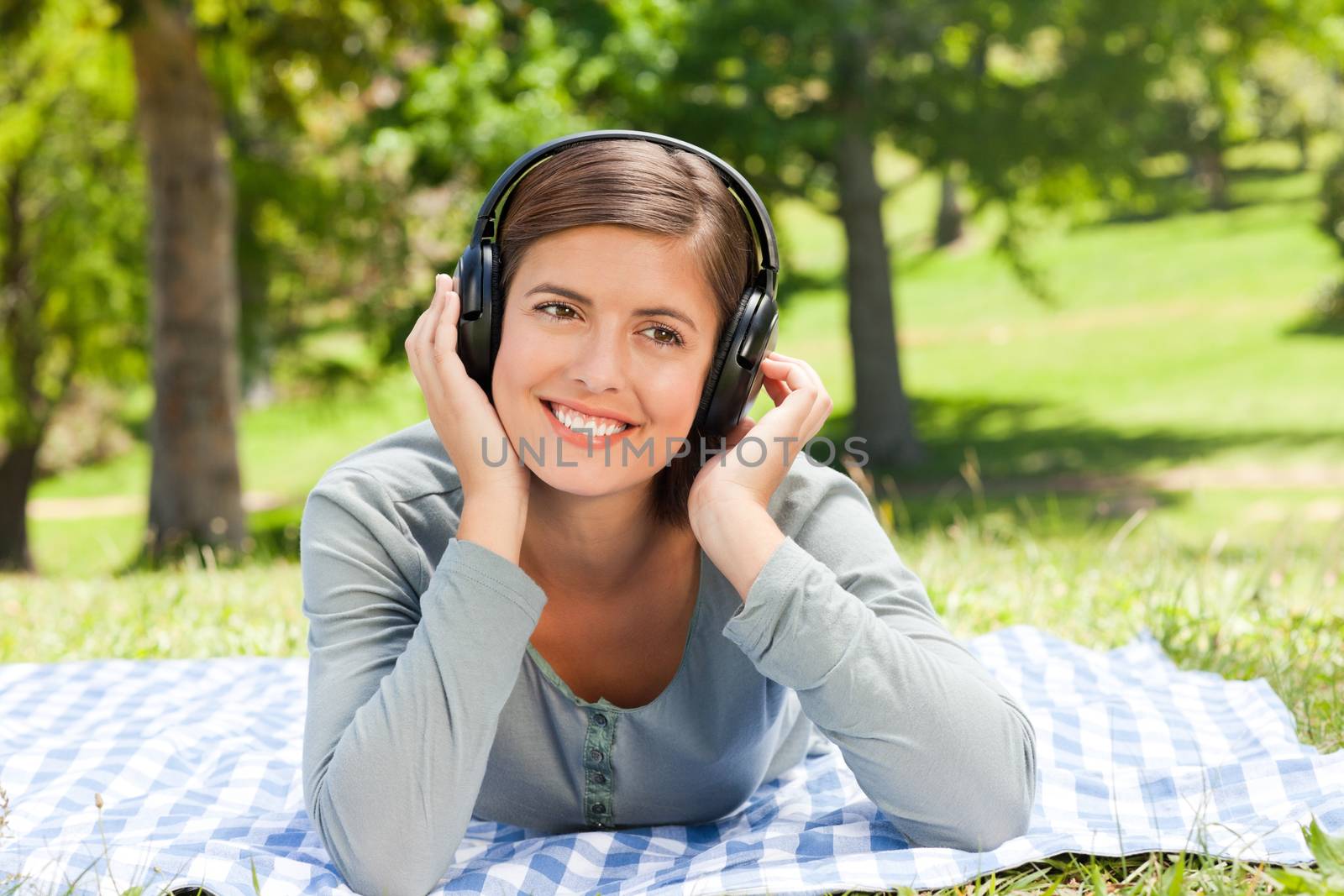 Woman listening to music in the park during the summer