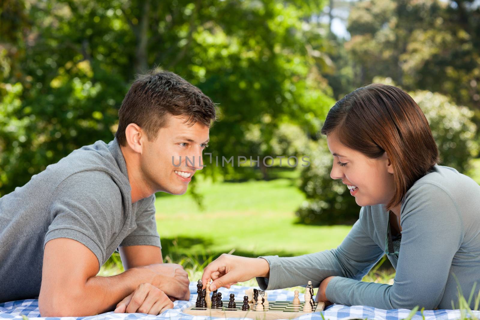 Couple playing chess in the park by Wavebreakmedia