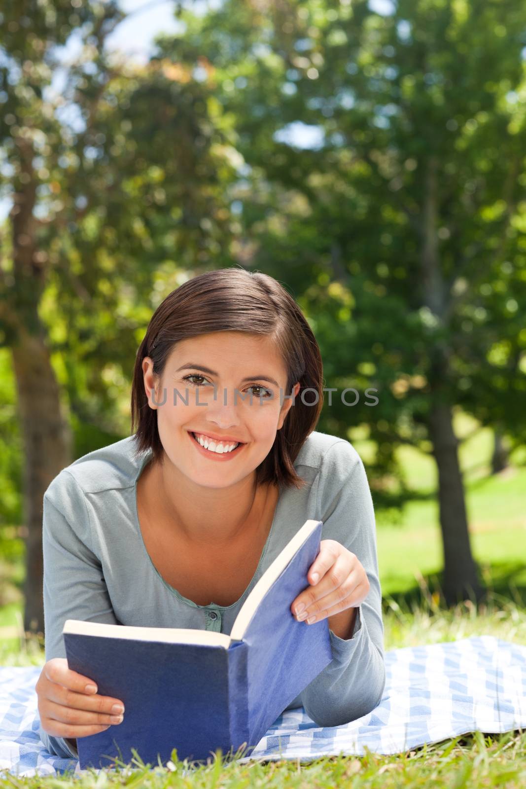 Woman reading a book in the park during the summer
