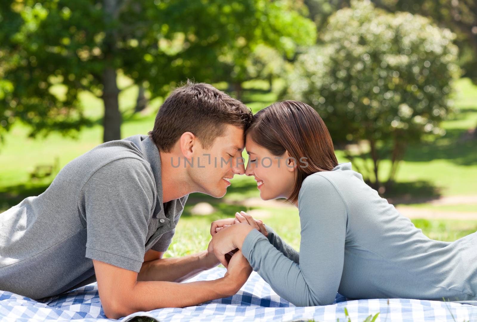 Enamored couple in the park during the summer