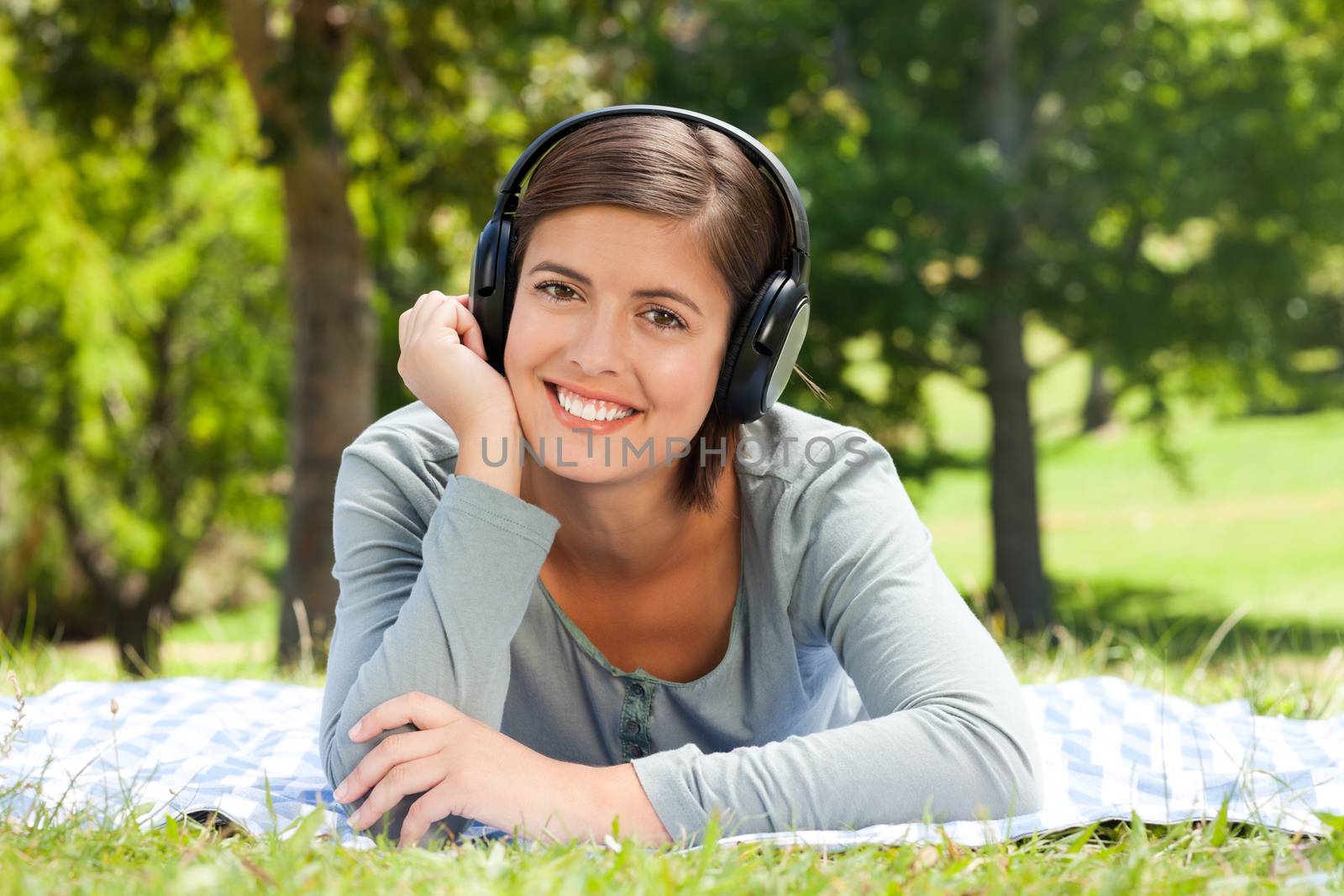 Woman listening to music in the park during the summer