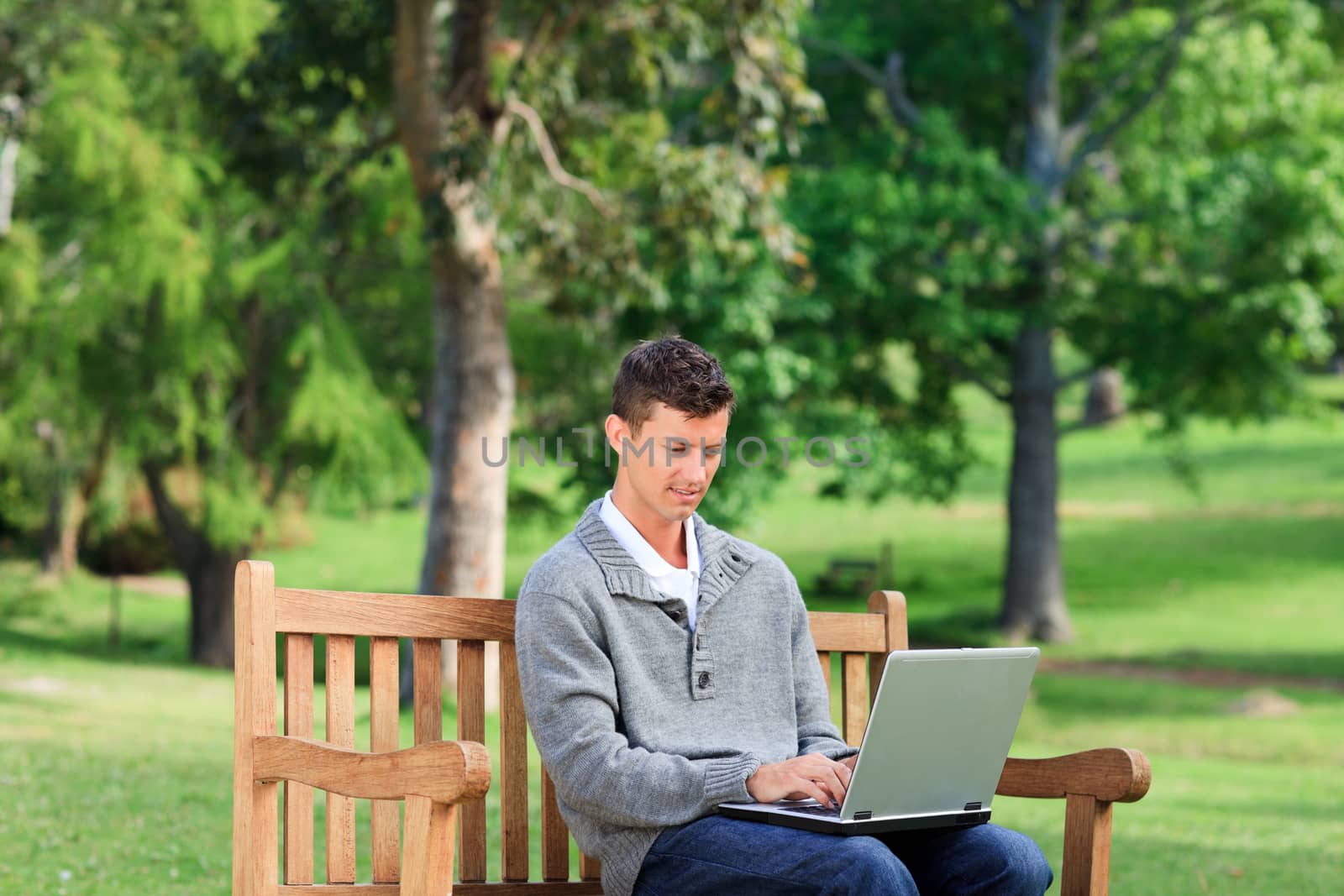 Concentrated man working on his laptop during the summer