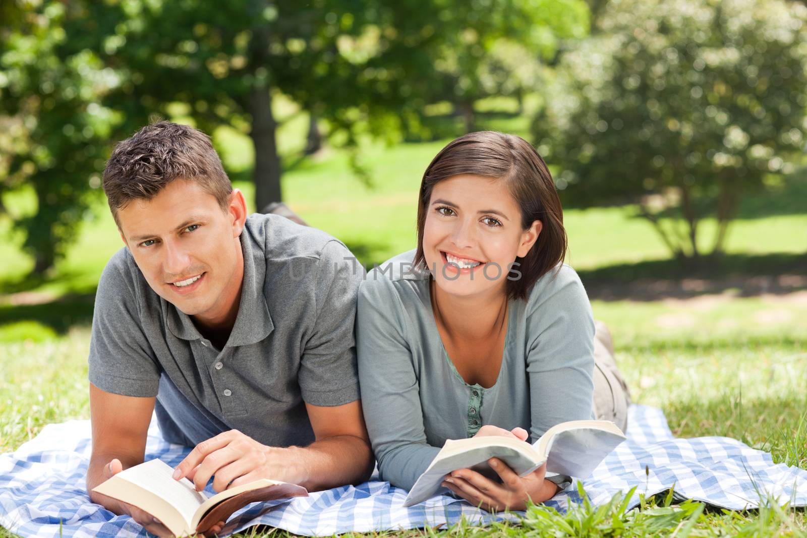 Couple reading a book during the summer