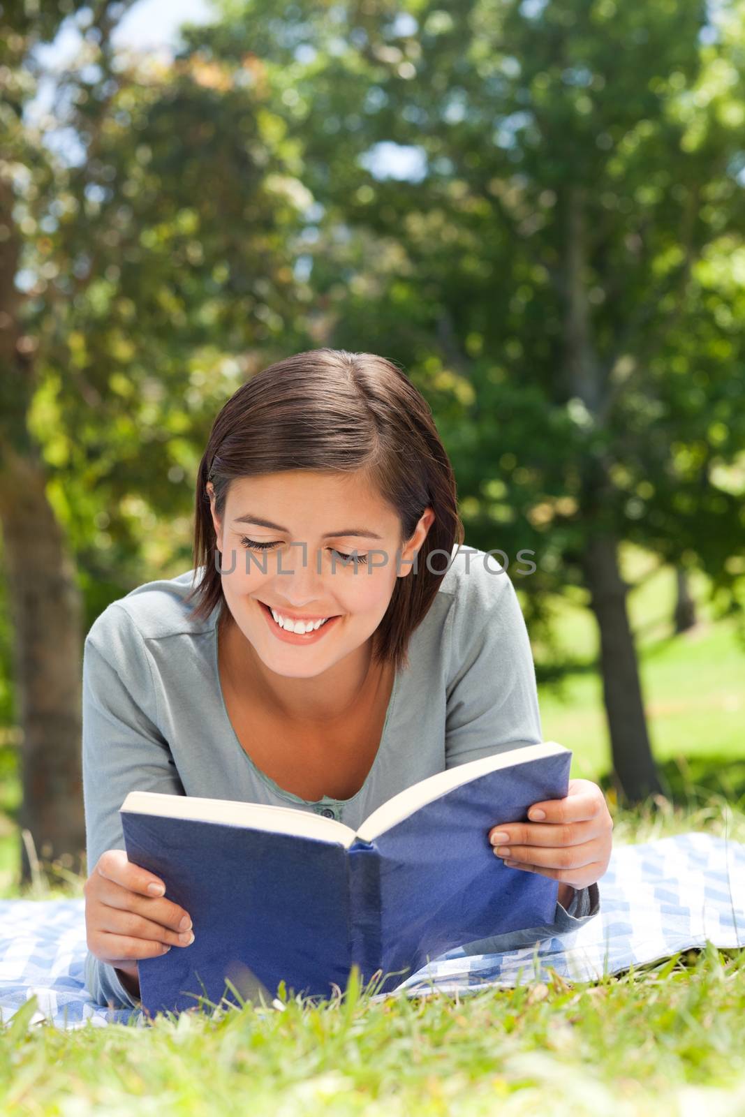 Woman reading a book in the park during the summer