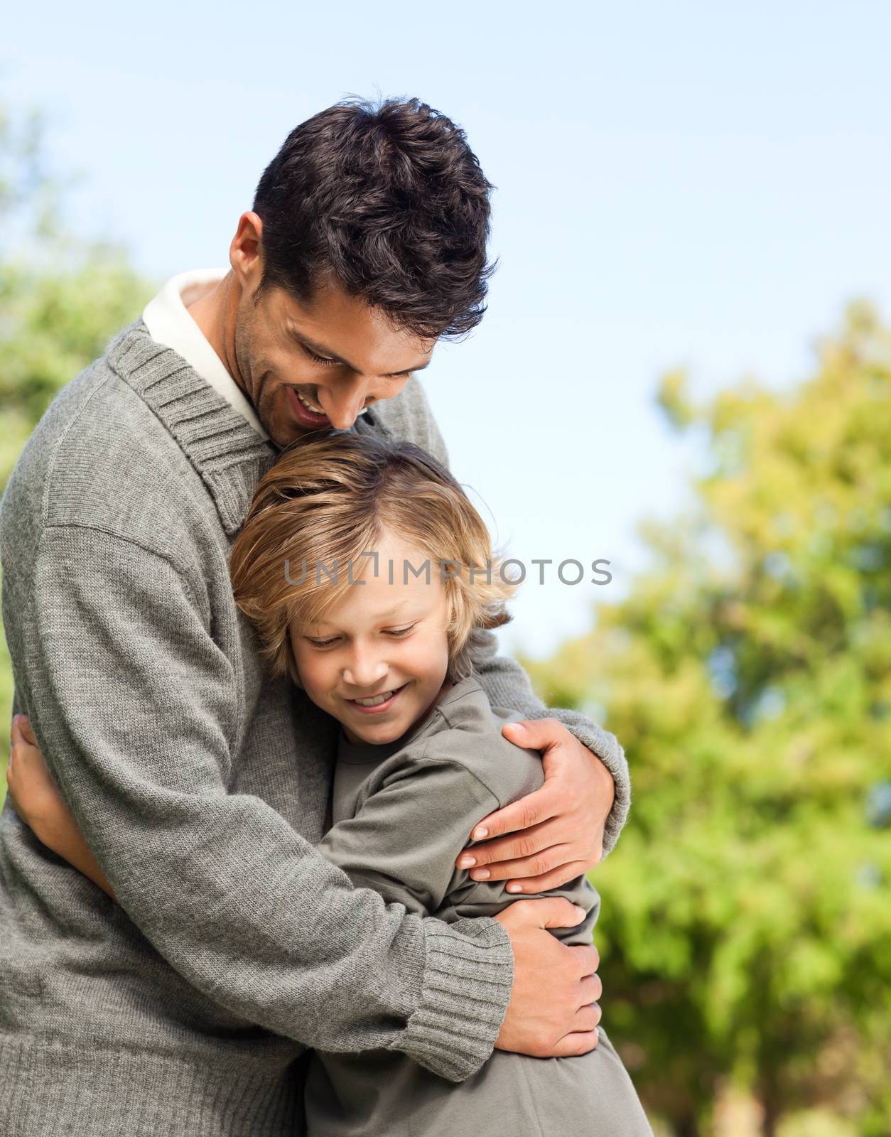 Son embracing his father during the summer