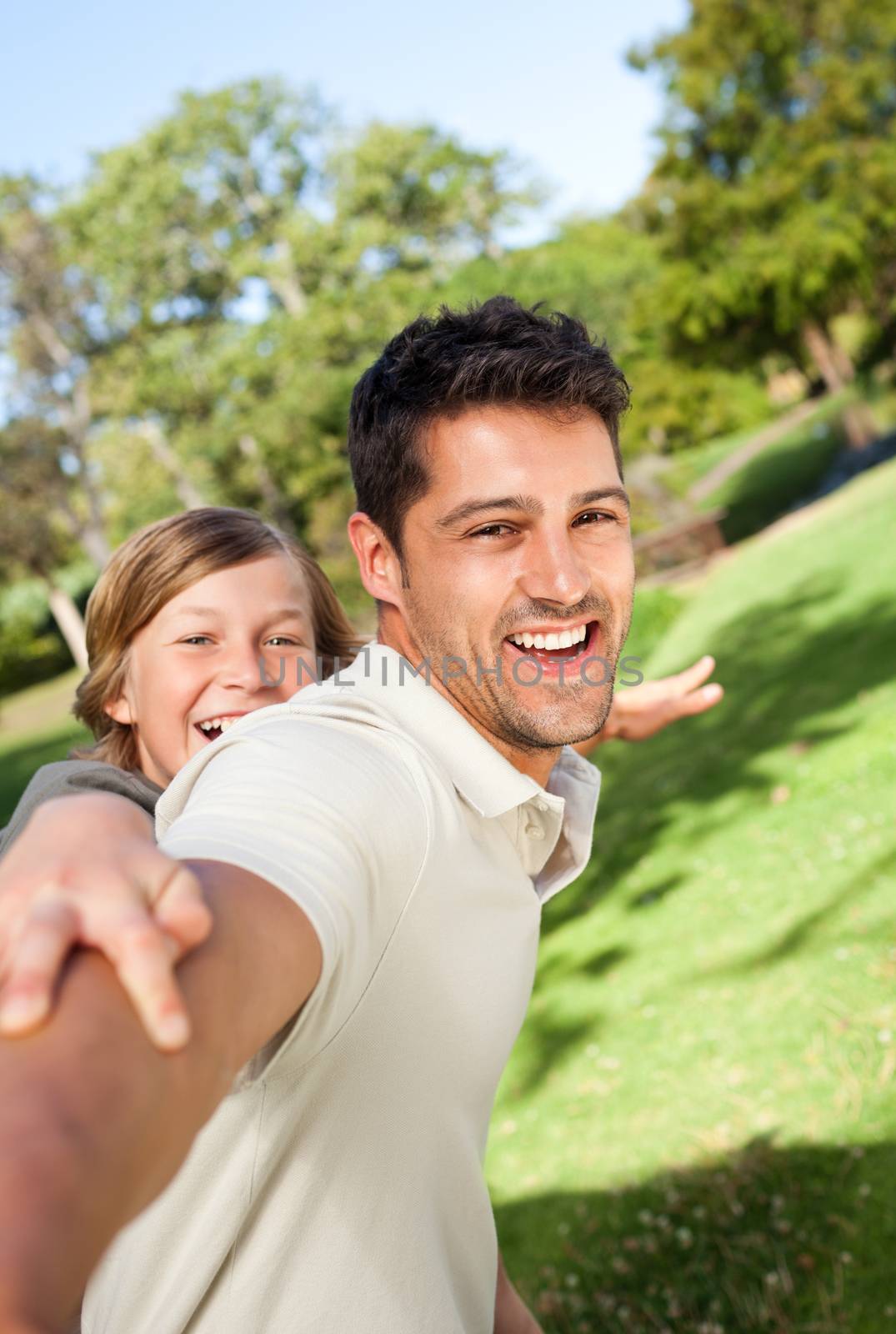 Father playing with his son in the park by Wavebreakmedia