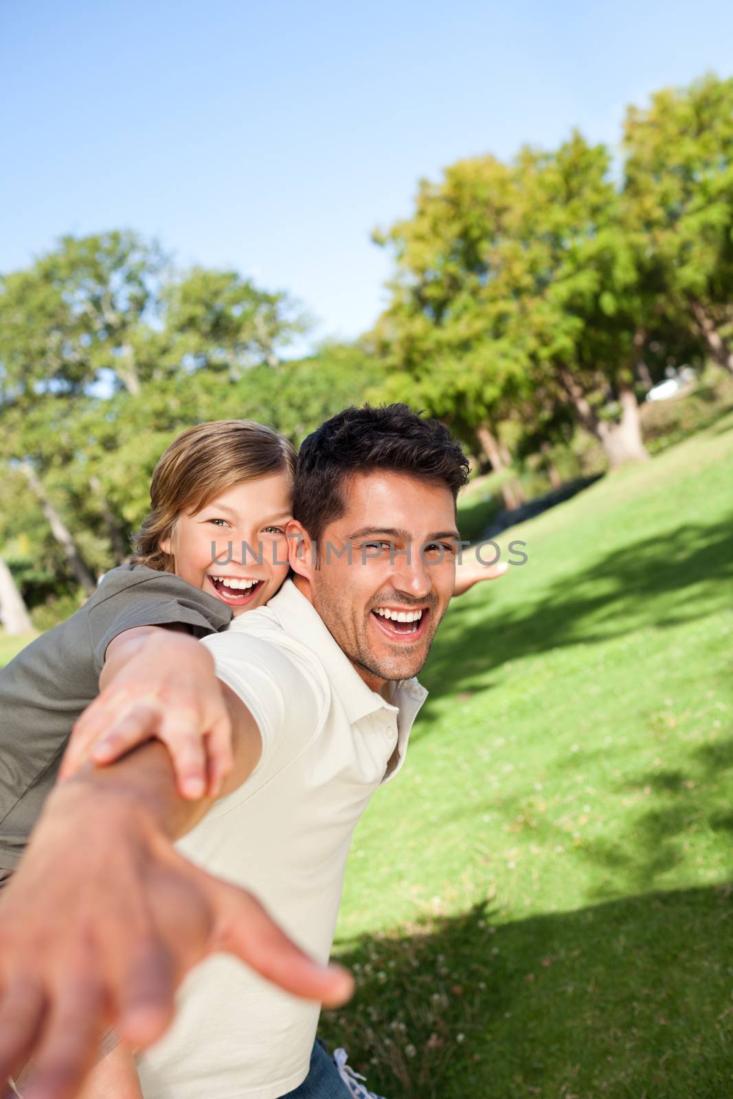 Father playing with his son in the park by Wavebreakmedia