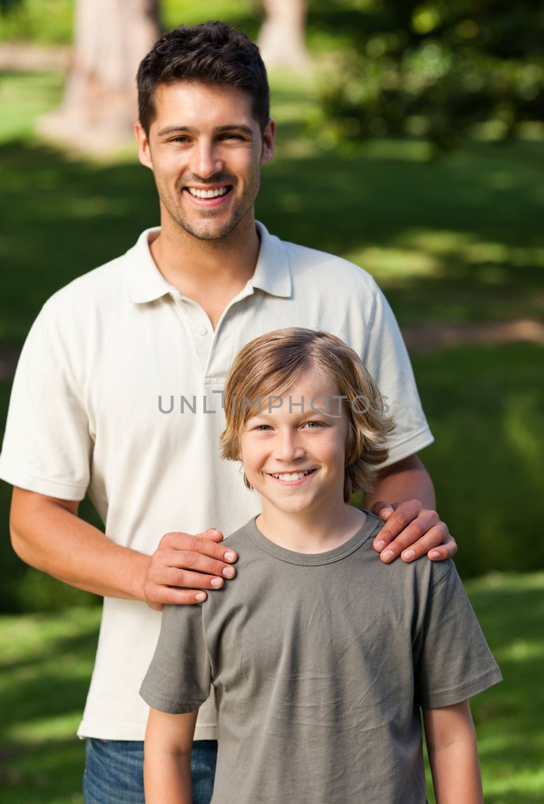 Son and his father in the park during the summer