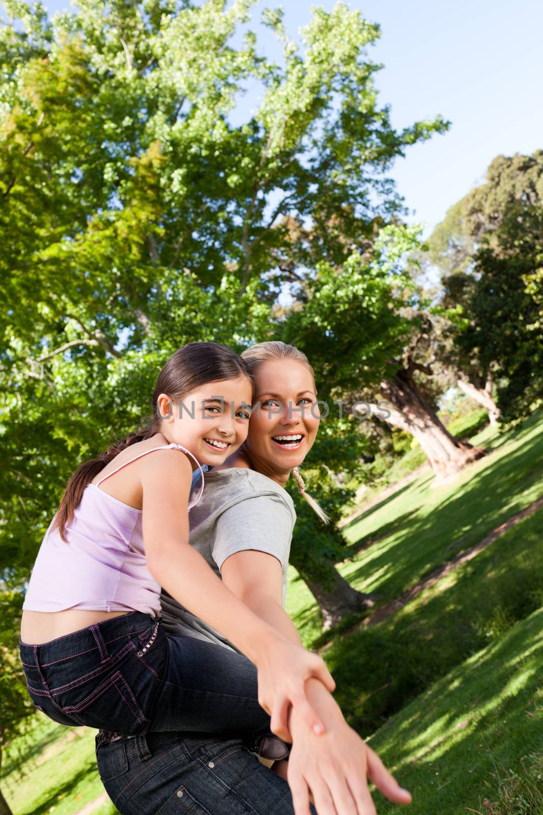 Daughter playing with her mother during the summer