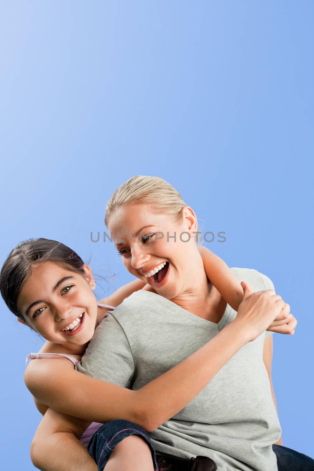 Mother and her daughter laughting in the park during the summer