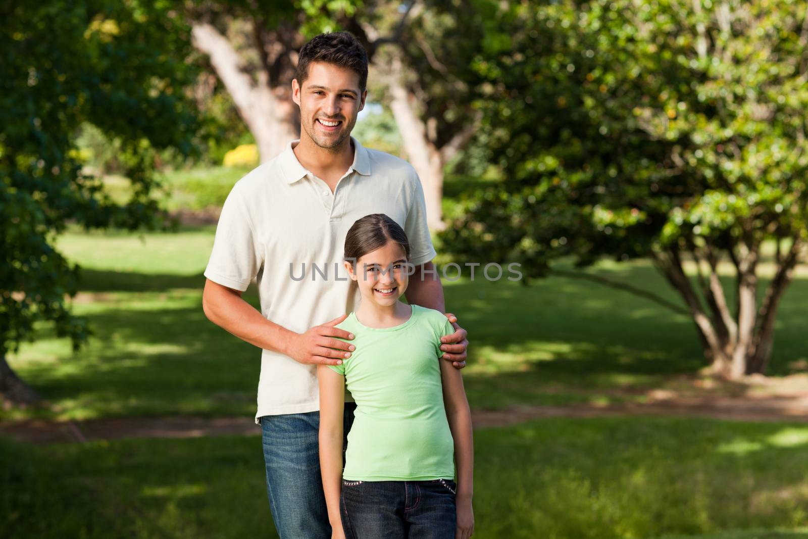 Daughter with her father in the park during the summer