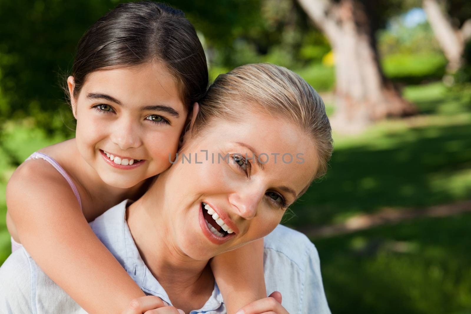 Cute daughter with her mother in the park during the summer