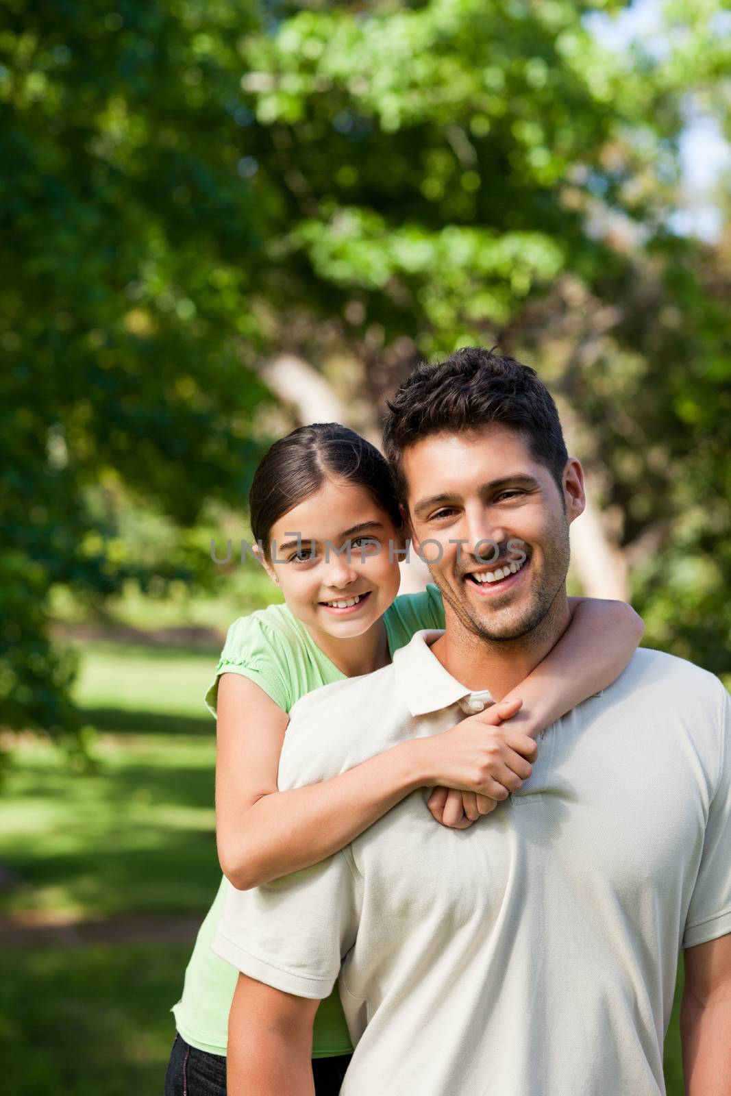 Daughter with her father in the park during the summer