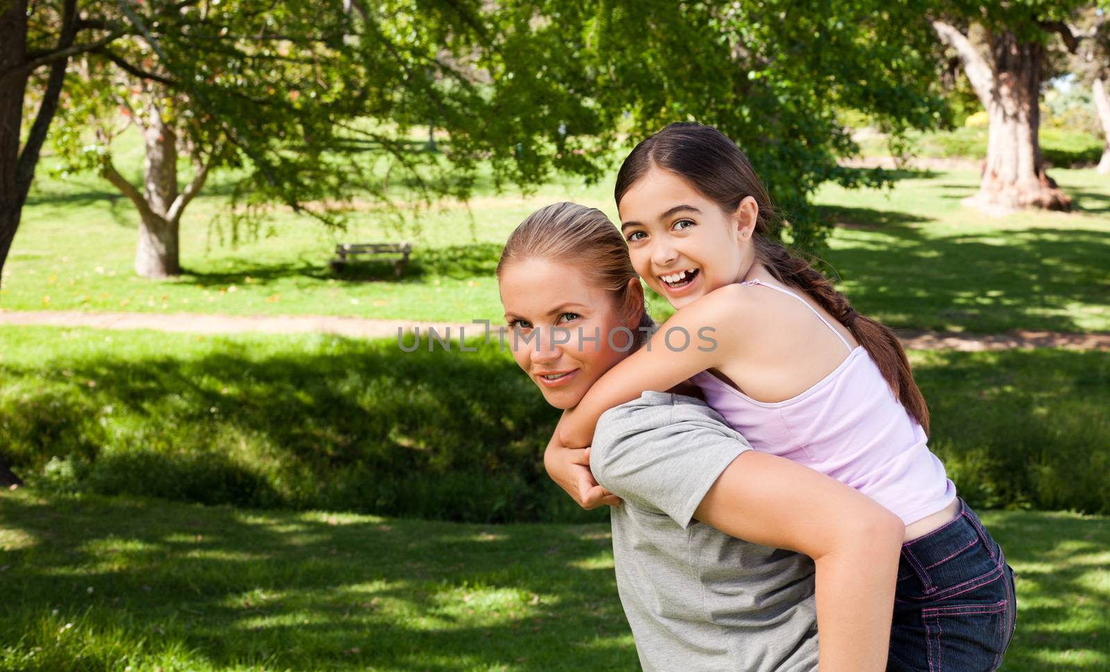 Daughter playing with her mother during the summer