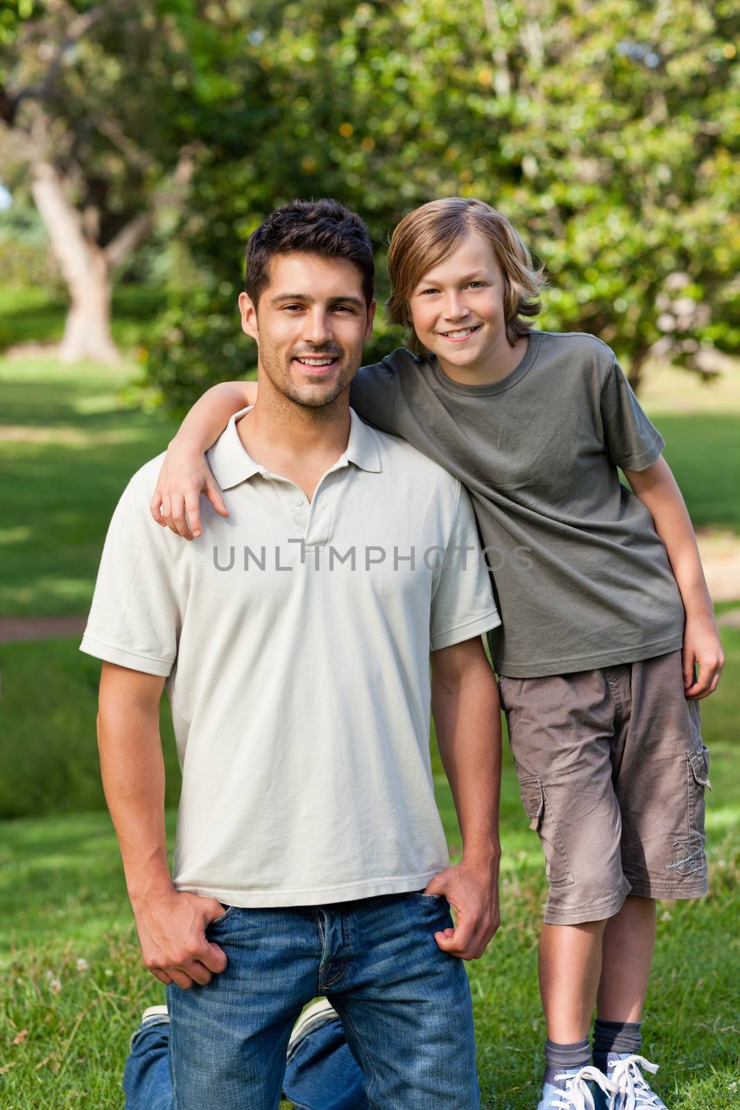 Son and his father in the park during the summer