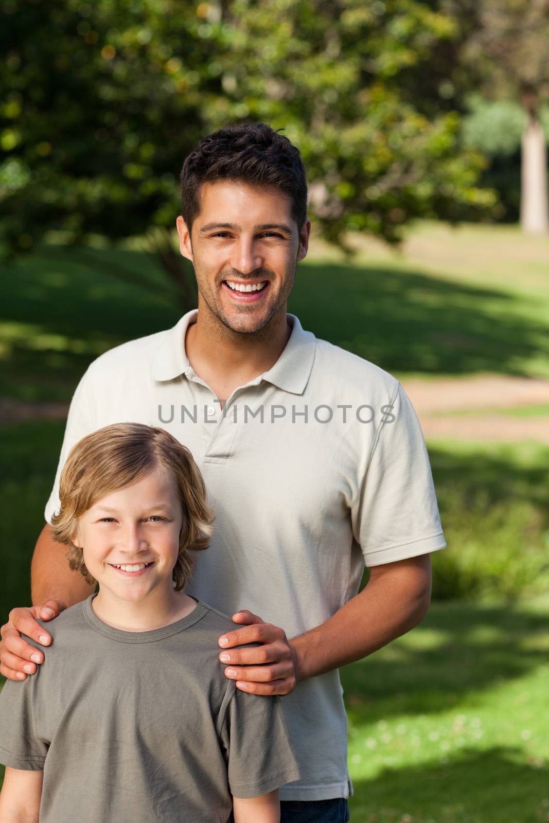 Son and his father in the park during the summer