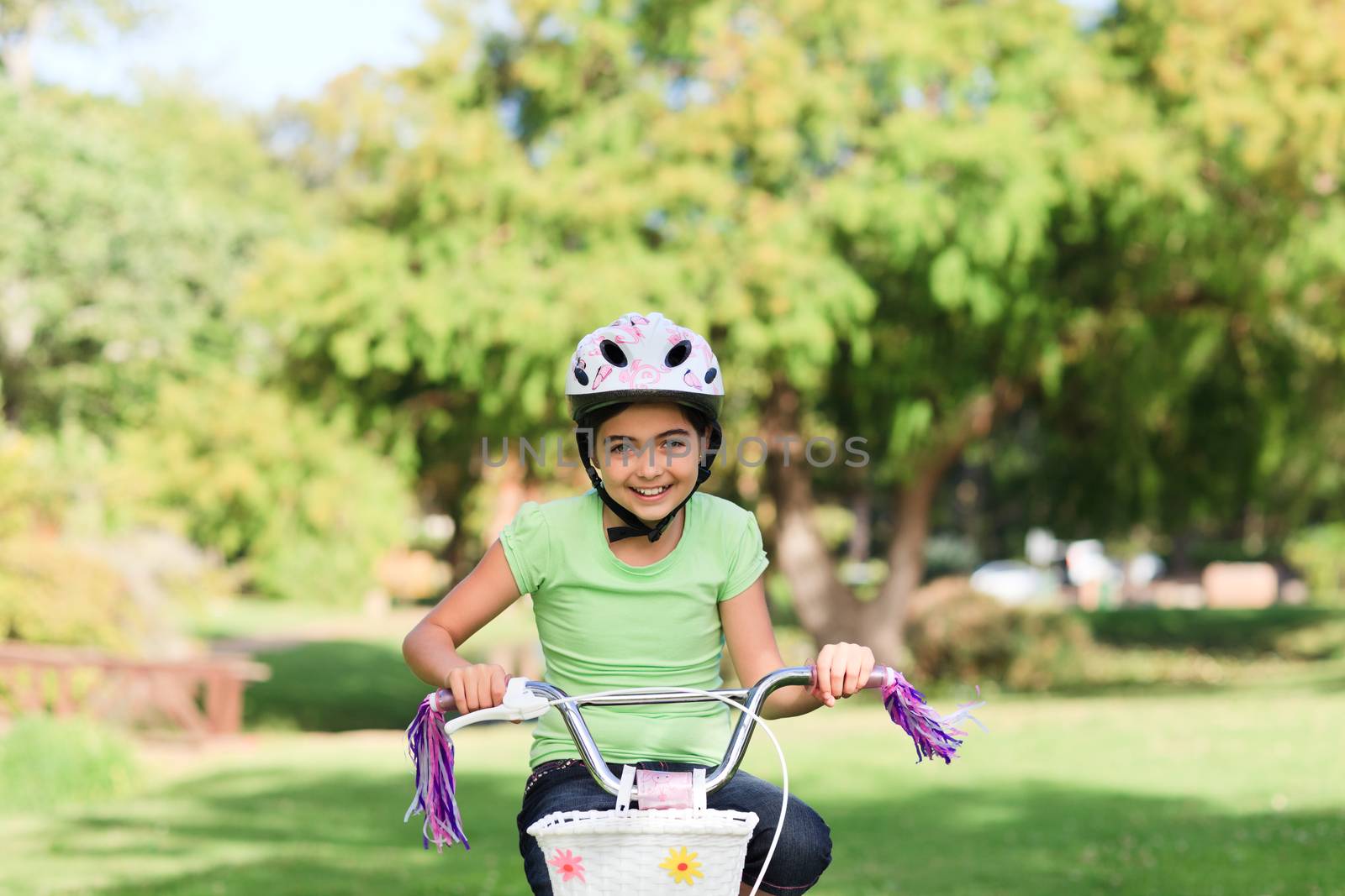 Little girl with her bike during the summer