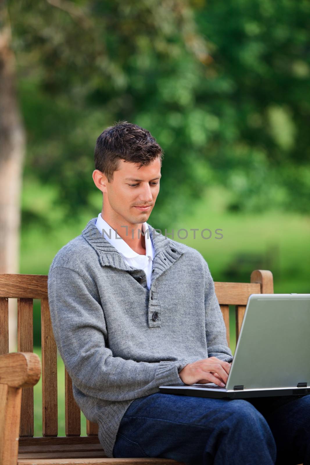 Concentrated man working on his laptop by Wavebreakmedia