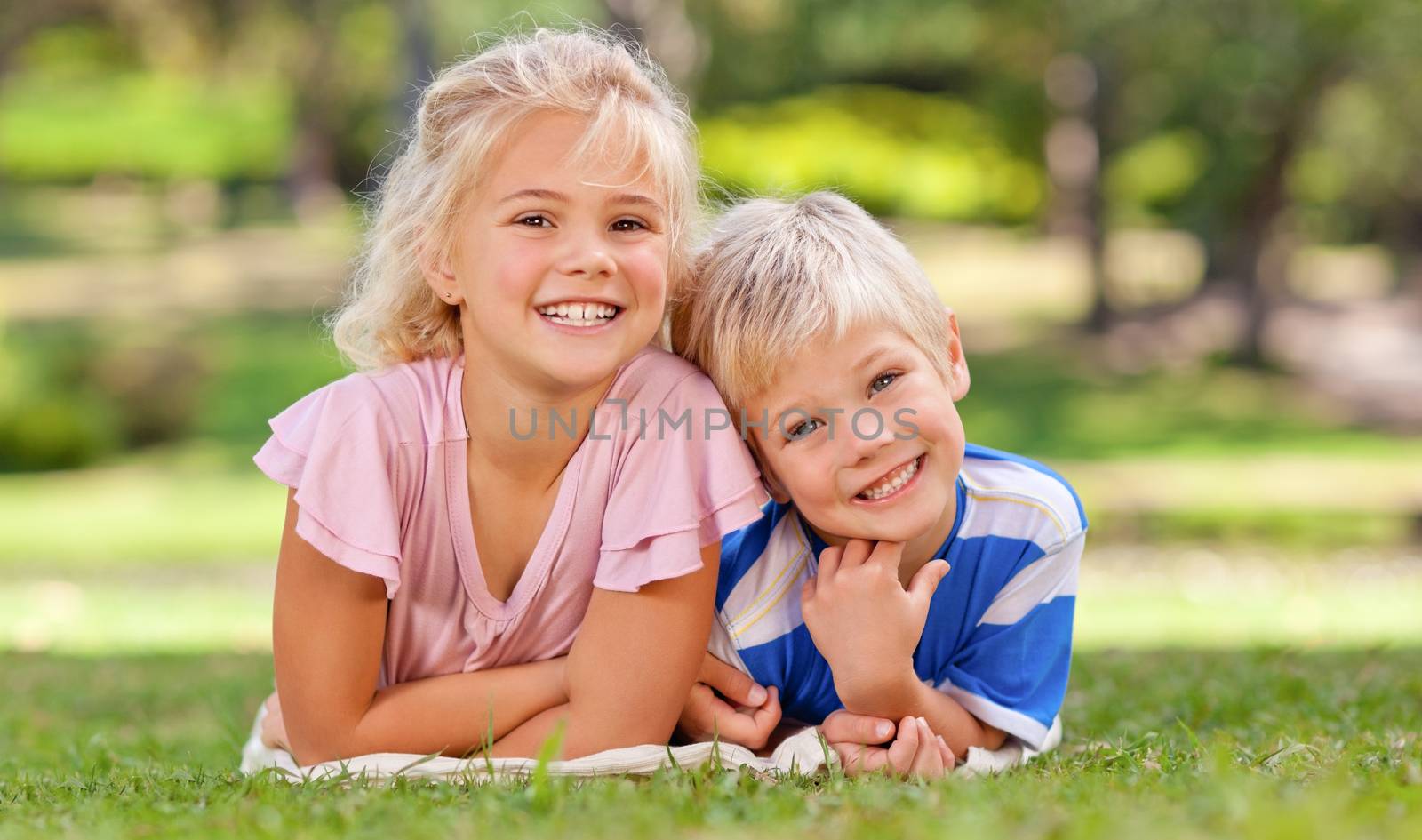 Boy with his sister in the park during the summer