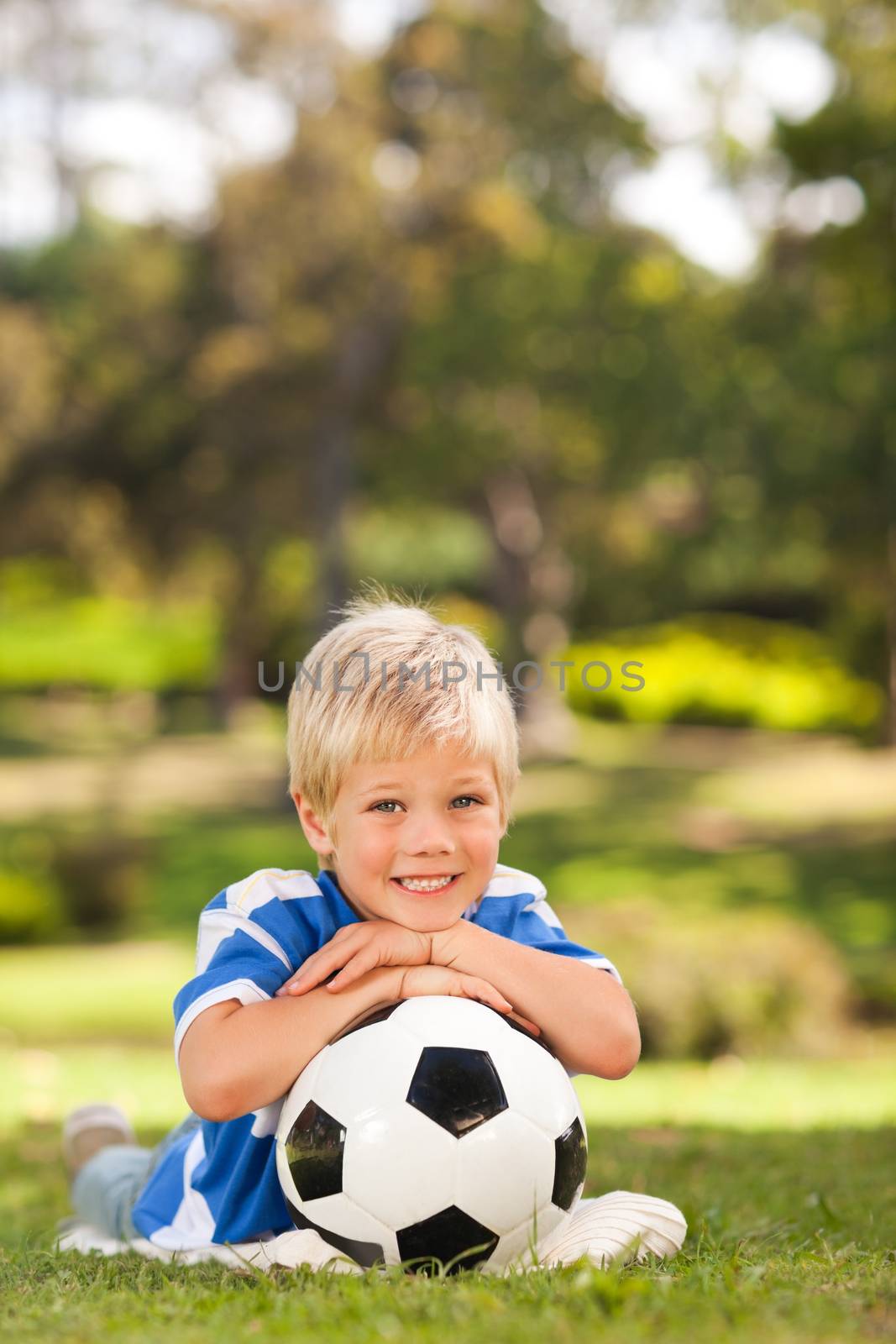Boy with his ball in the park during the summer 