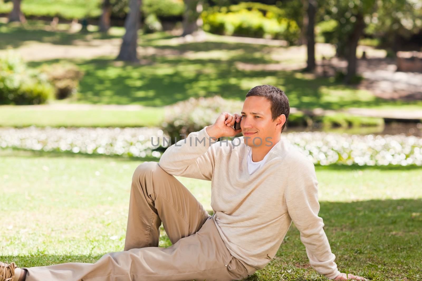 Man phoning in the park during the summer 