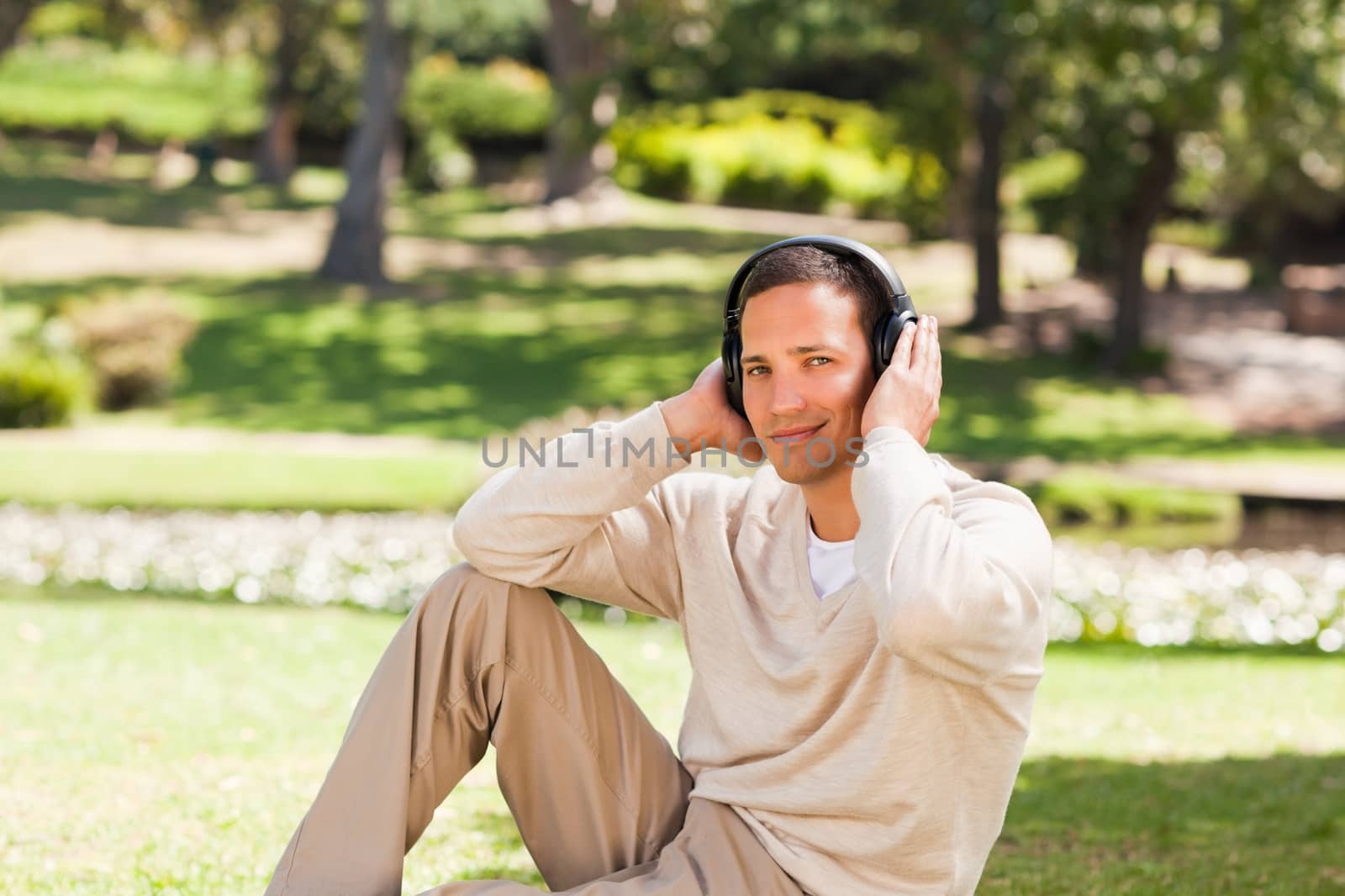 Man listening to music in the park by Wavebreakmedia