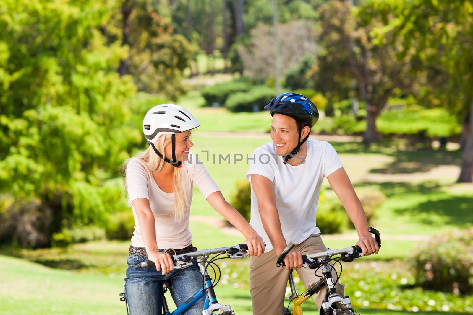 Couple with their bikes in the park during the summer 