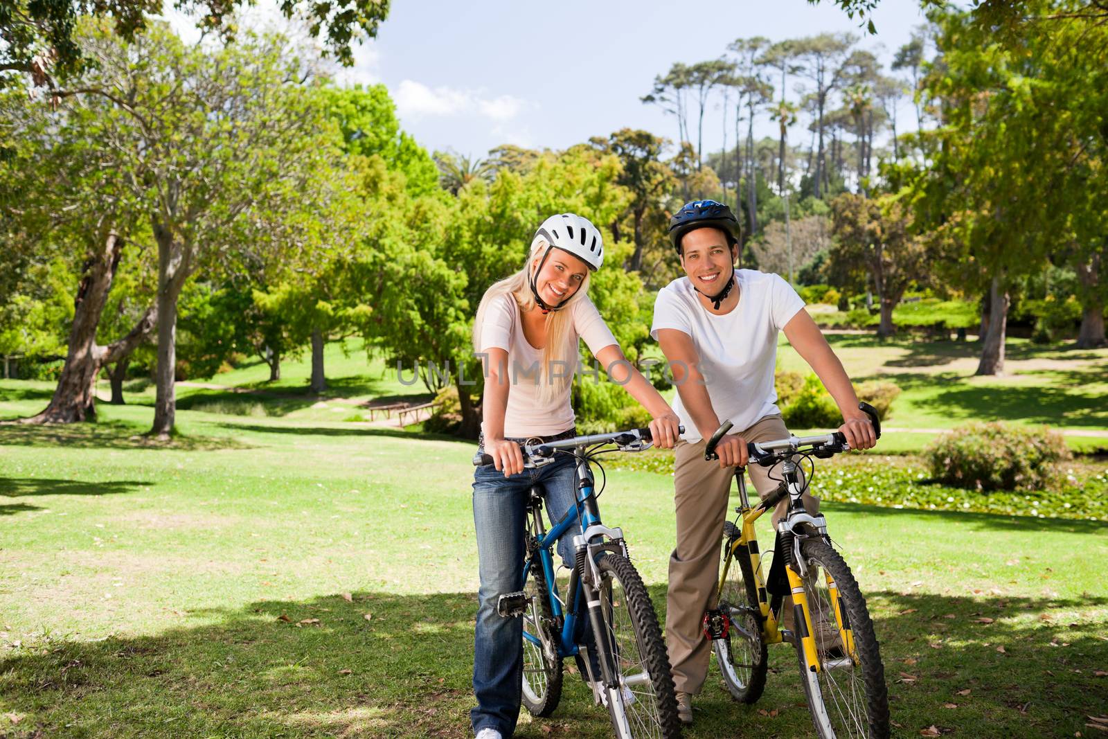 Couple in the park with their bikes during the summer 