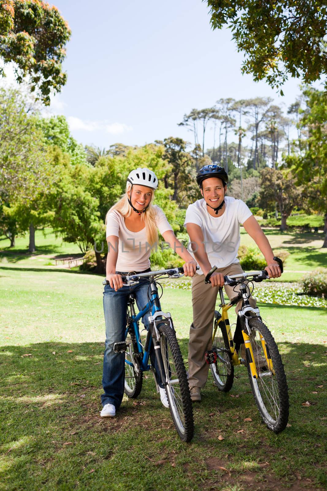 Couple in the park with their bikes during the summer 