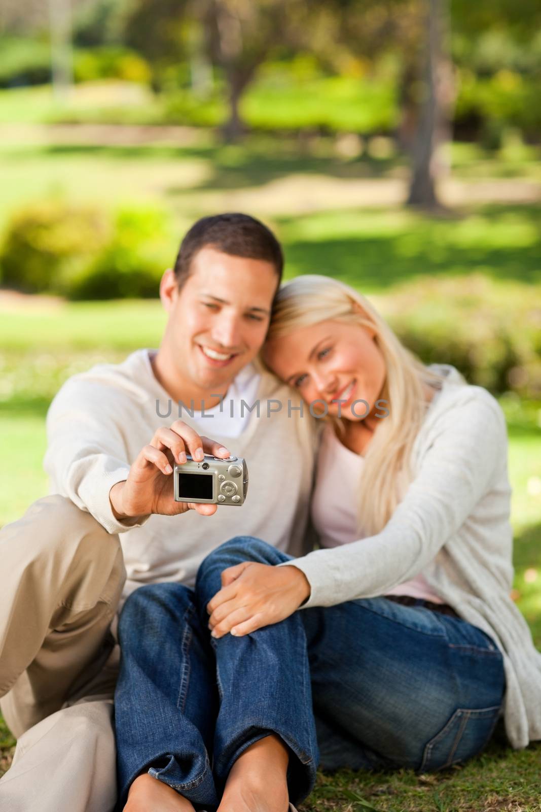 Young couple taking a photo of themselves during the summer 