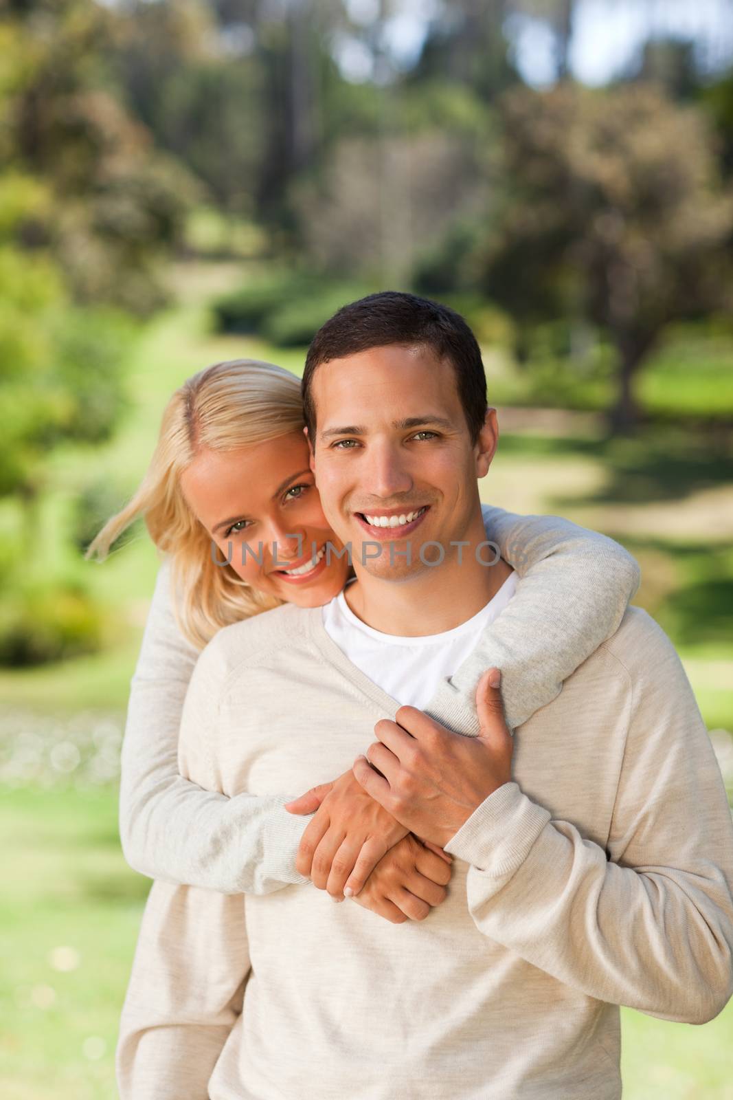 Woman hugging her boyfriend in the park by Wavebreakmedia