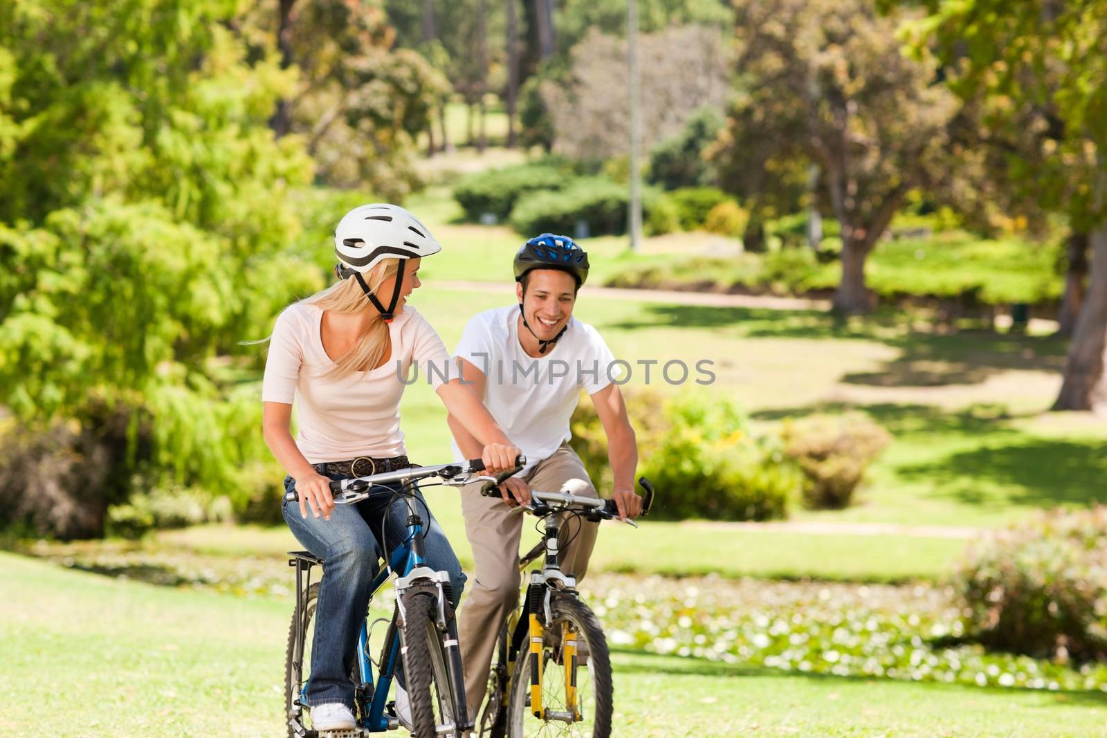 Couple with their bikes in the park by Wavebreakmedia