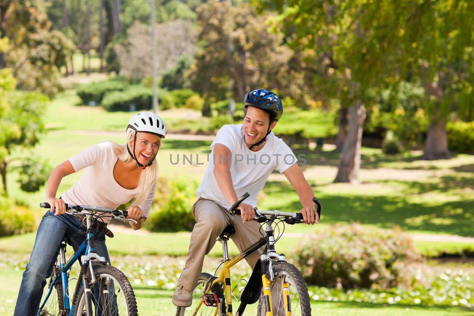 Couple with their bikes during the summer  by Wavebreakmedia