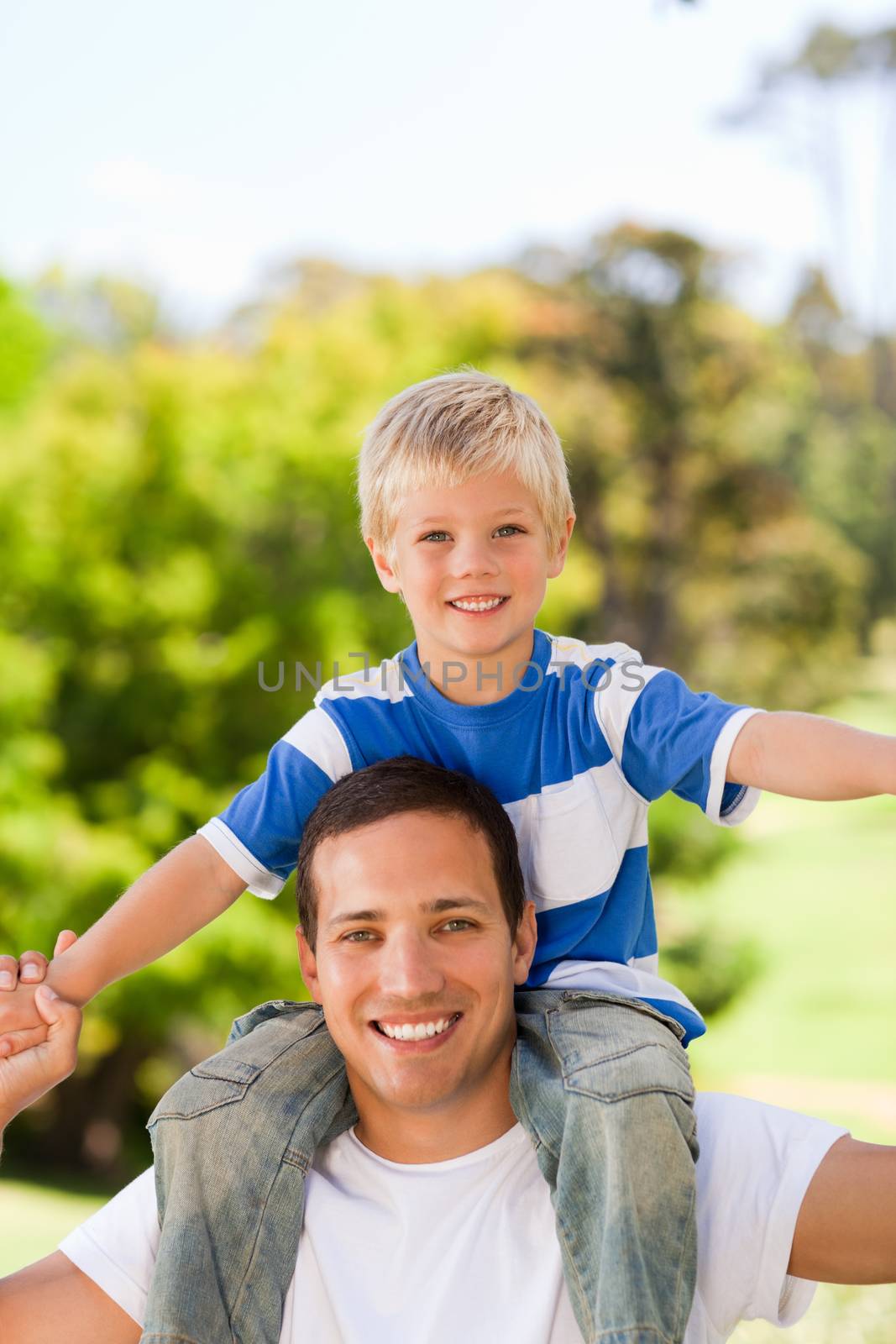 Man giving son a piggyback by Wavebreakmedia