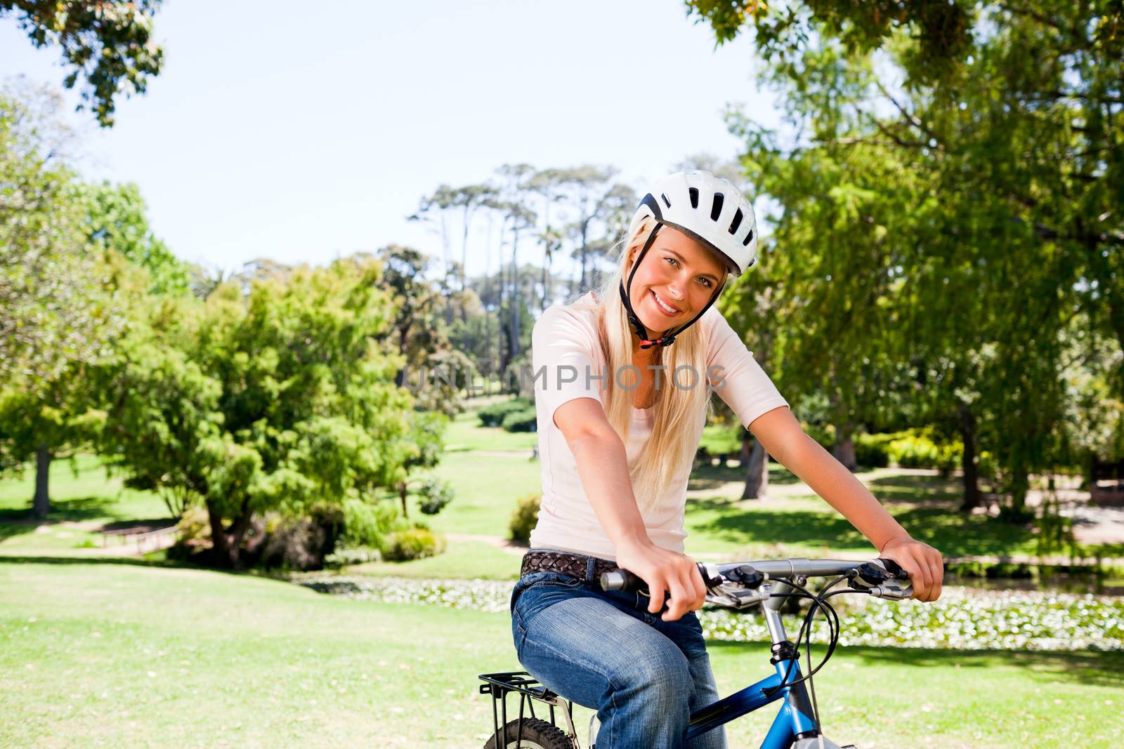 Woman in the park with her bike during the summer 