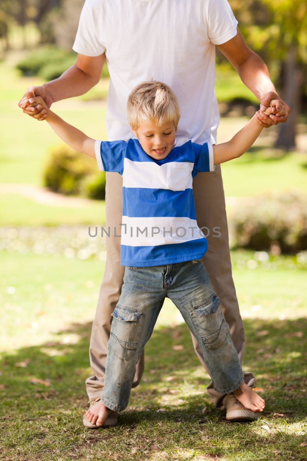 Father playing with his son in the park by Wavebreakmedia