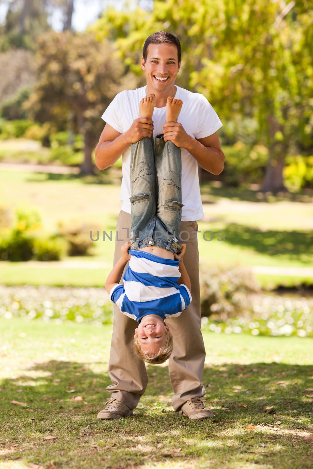 Father playing with his son in the park by Wavebreakmedia