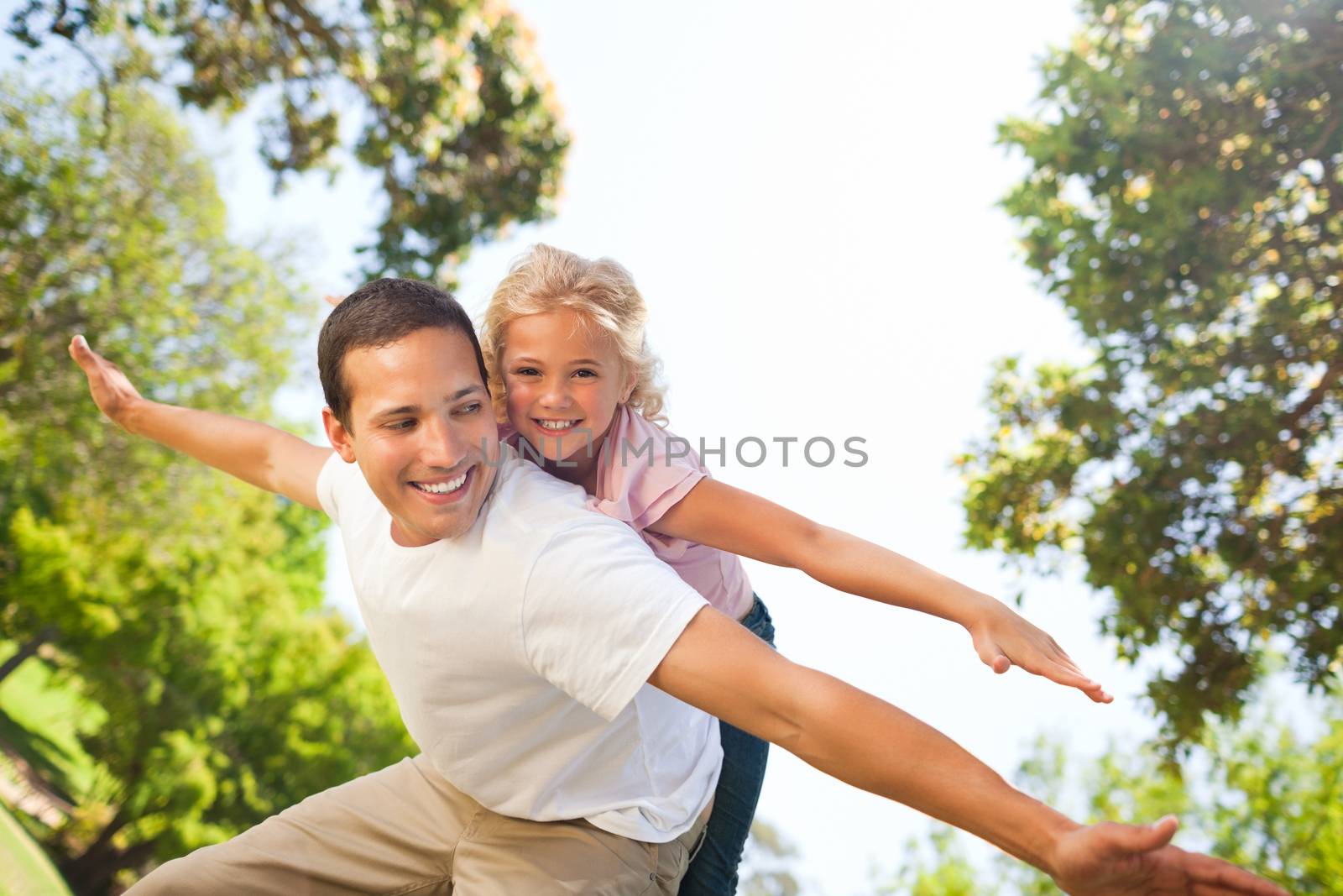 Father playing with his daughter in the park by Wavebreakmedia