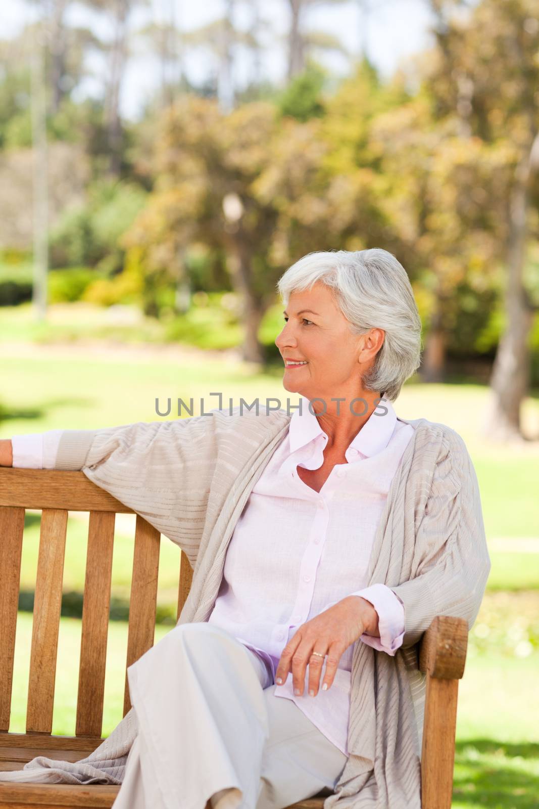 Senior woman on a bench during the summer  by Wavebreakmedia