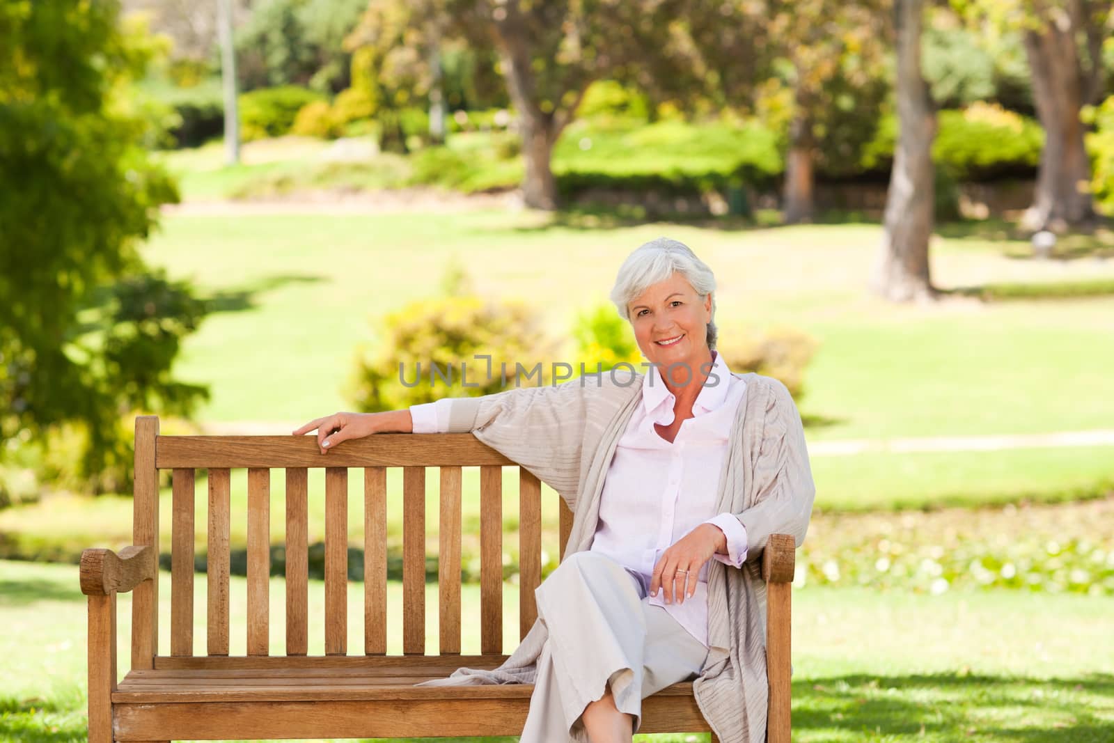 Senior woman on a bench during the summer 