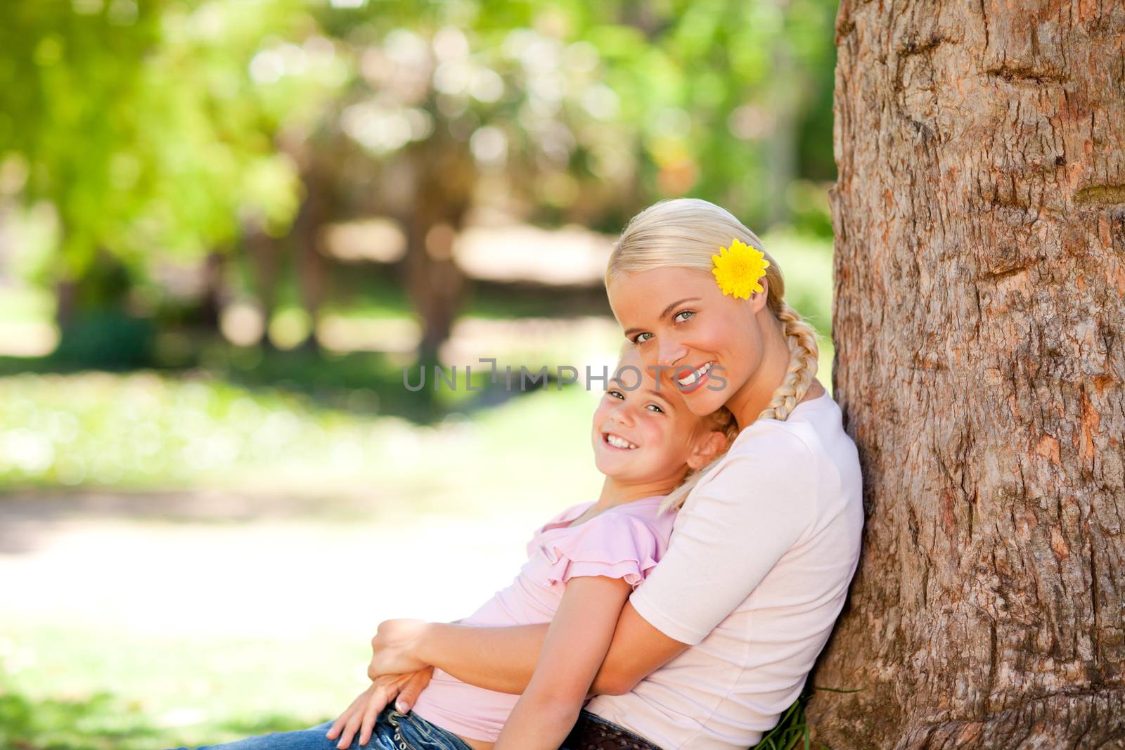 Lovely mother with her daughter during the summer in a park