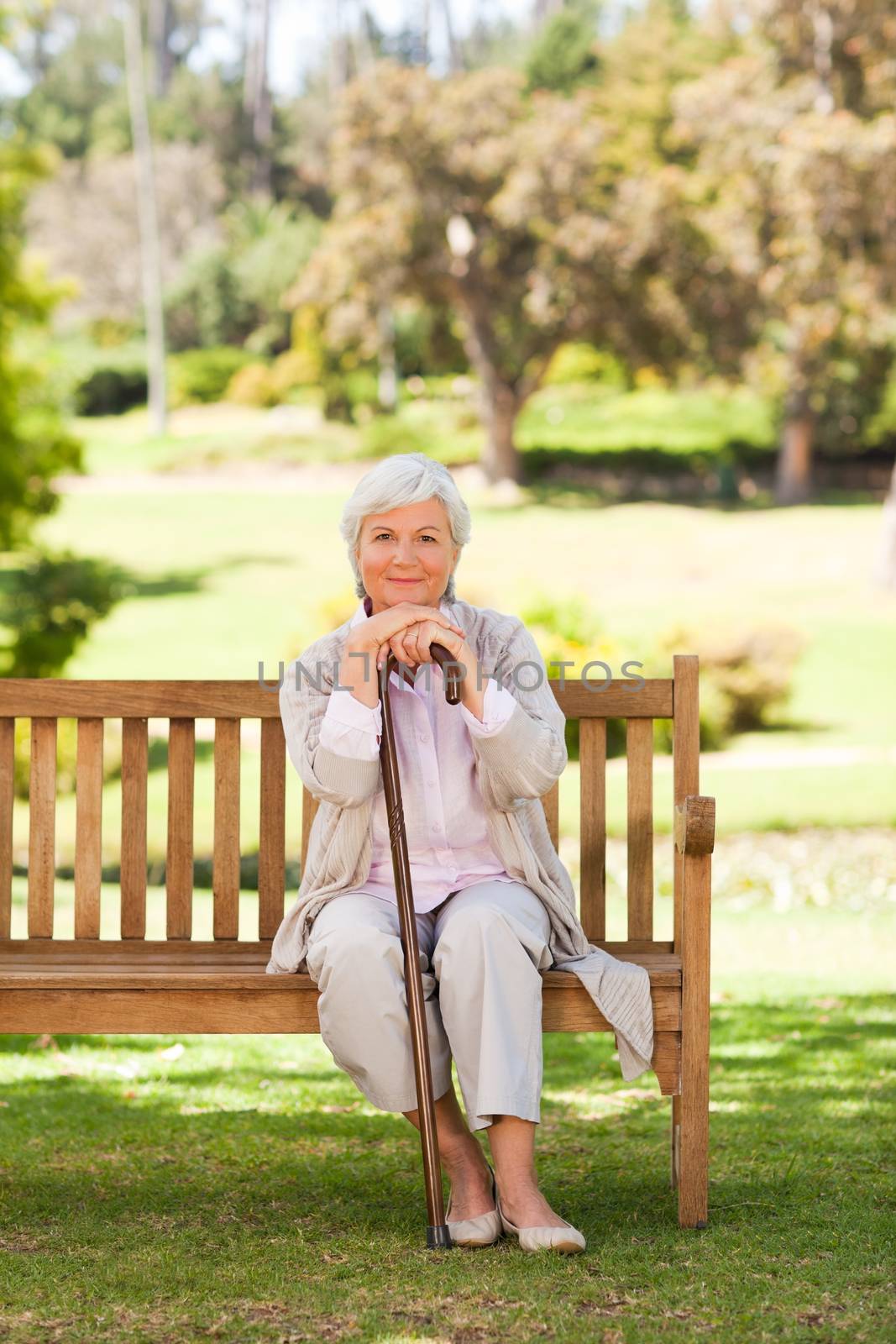 Woman with her walking stick in the park during the summer 