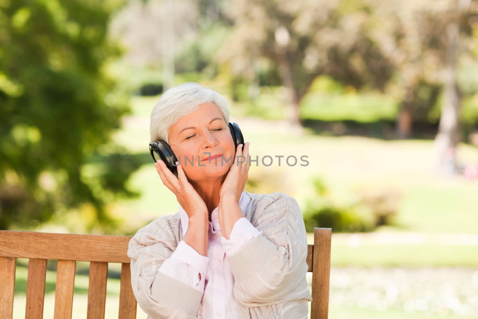 Senior woman listening to some music during the summer  by Wavebreakmedia
