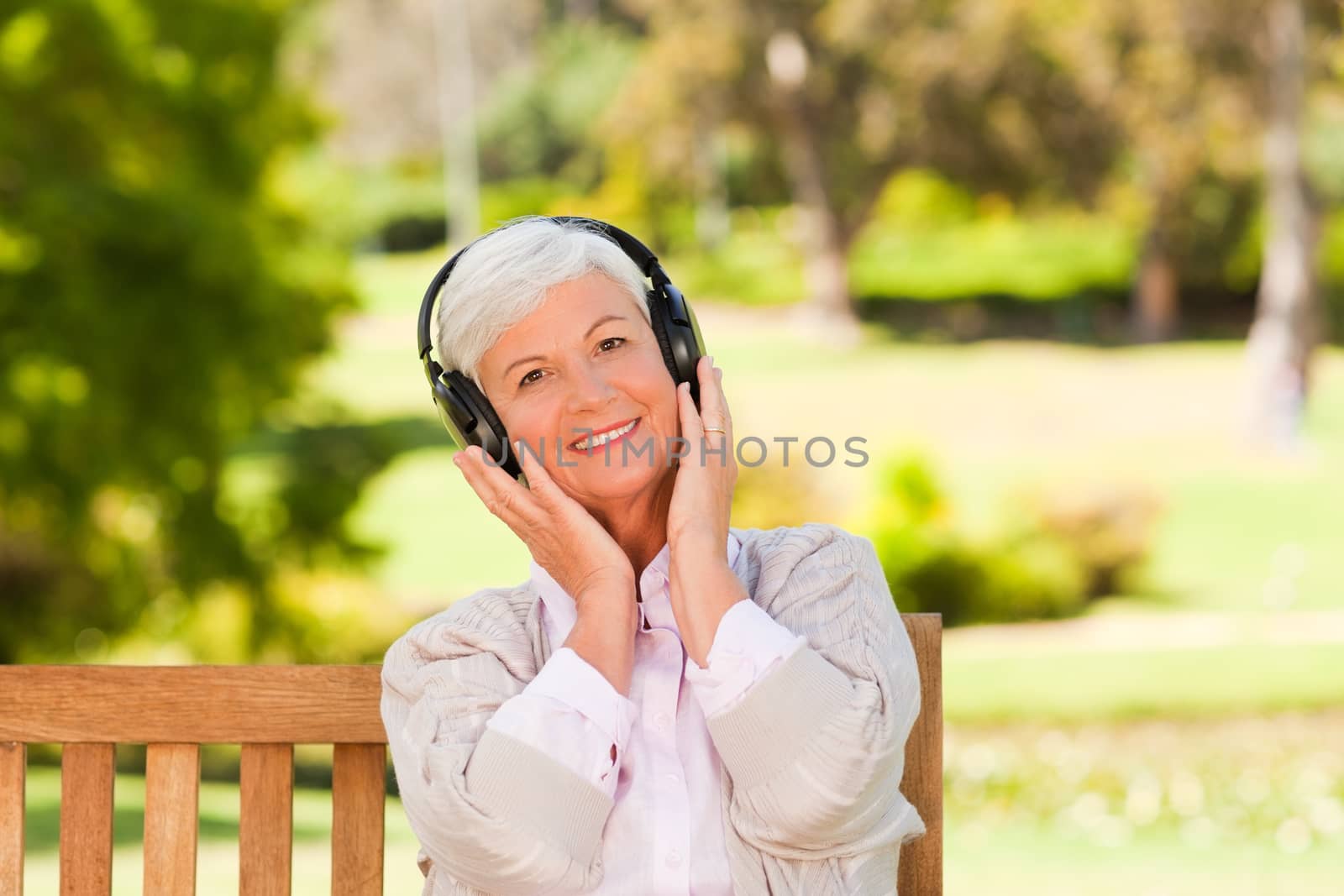 Senior woman listening to some music during the summer 