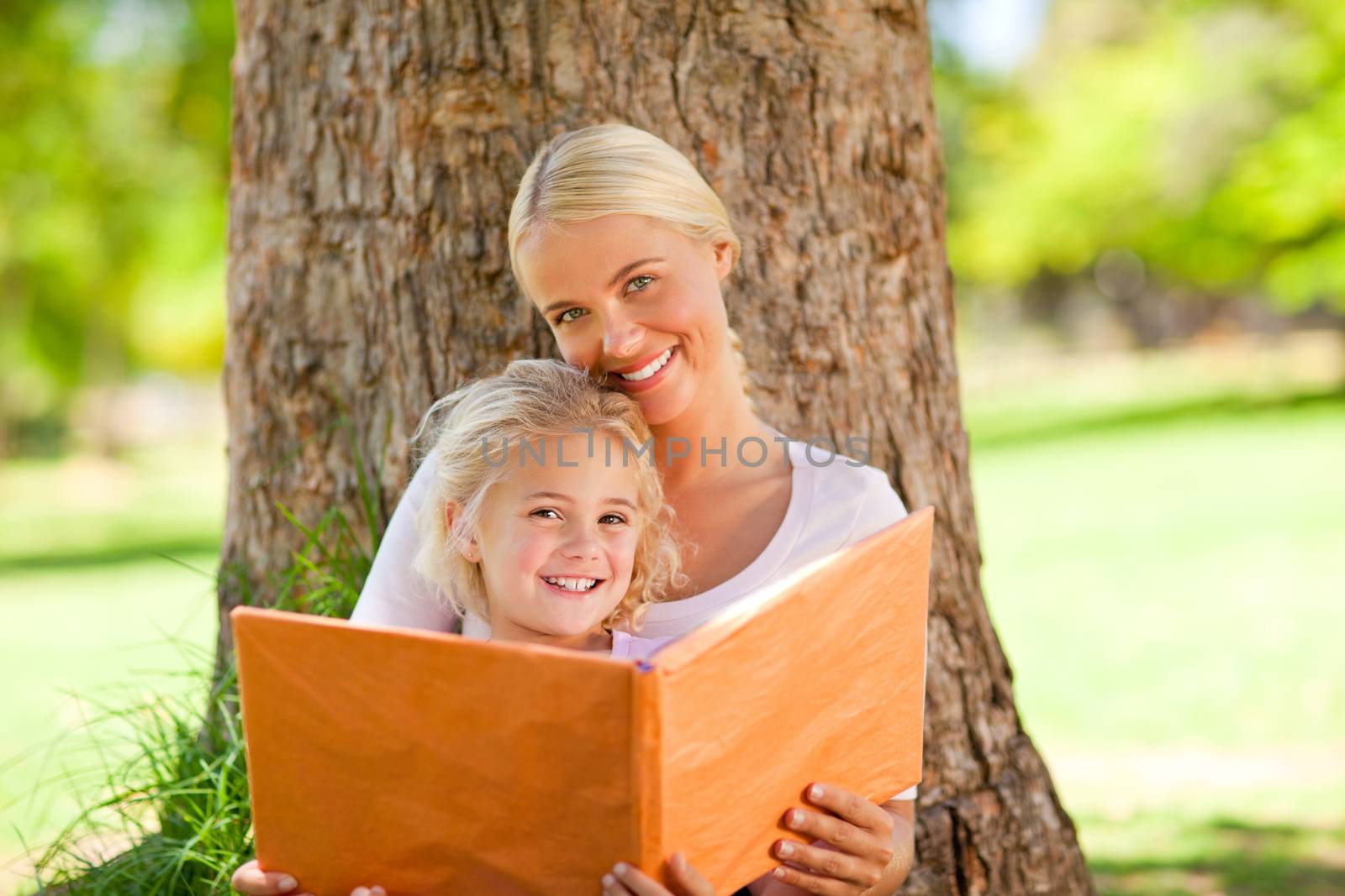 Daughter and her mother looking at their album photo during the summer 